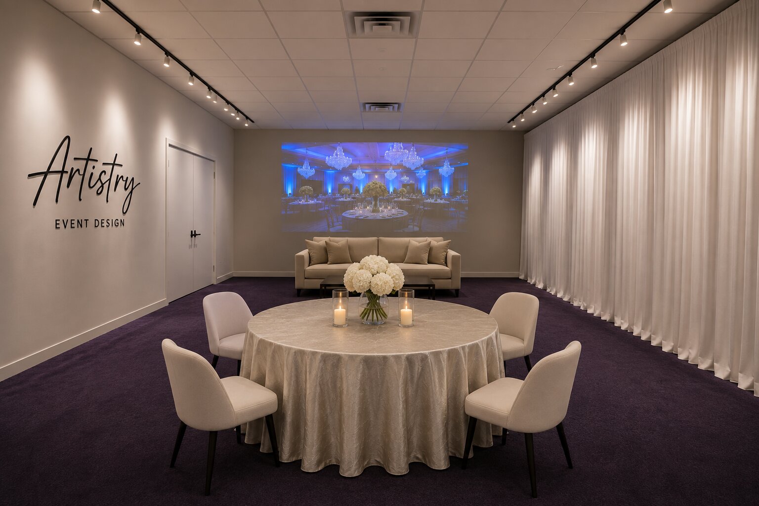 The Artistry Event Design showroom with a dressed table and lounge