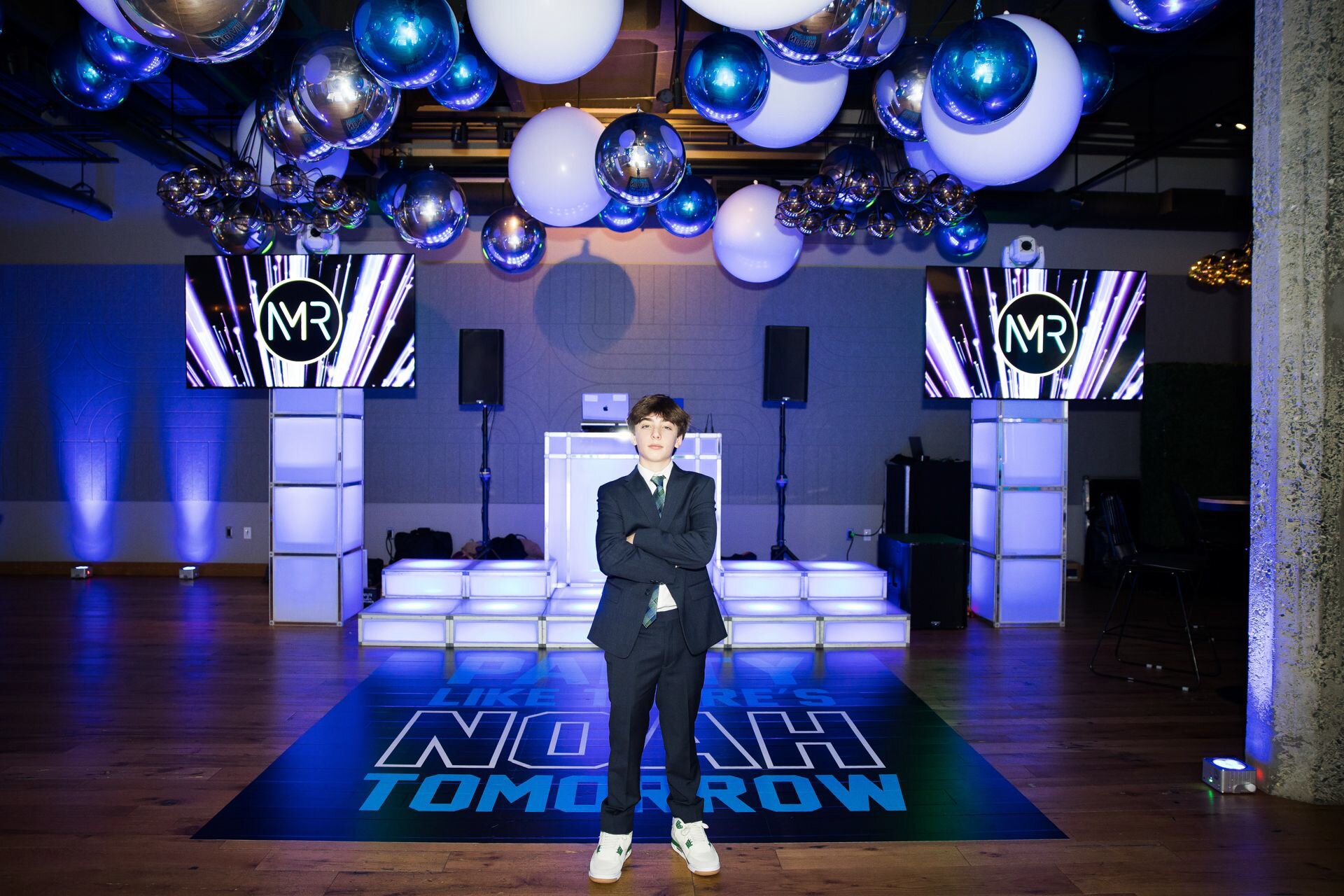 Blue and silver balloon ceiling over a dance floor