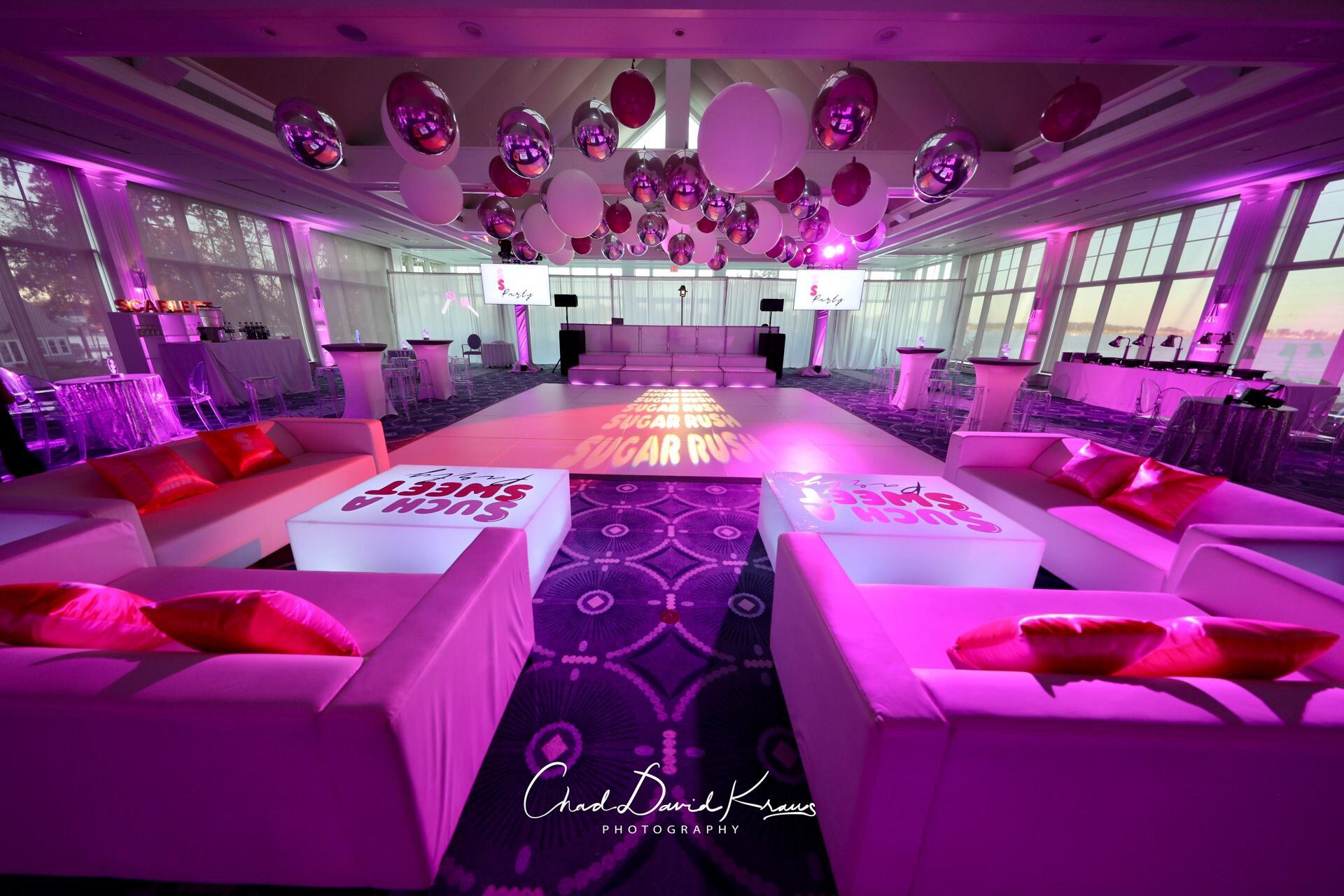 Pink-lit lounge with white furniture