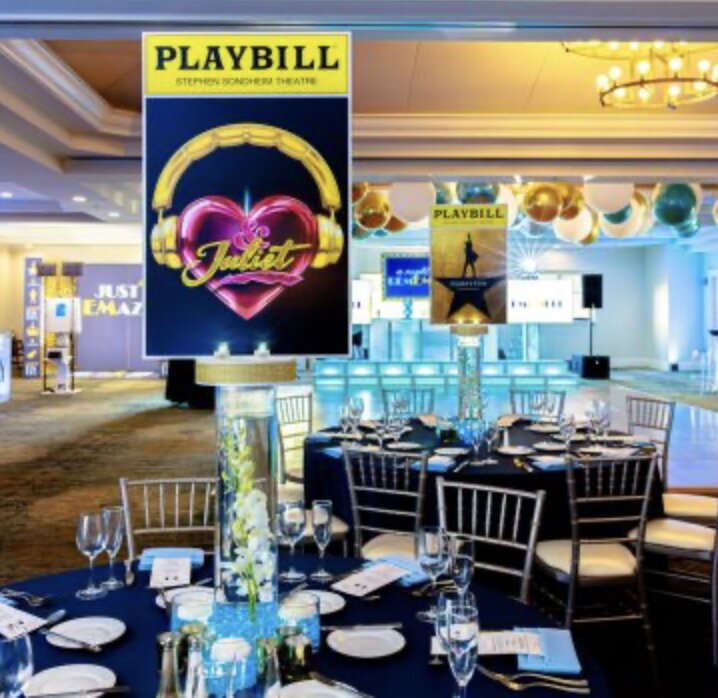 Broadway-themed tables with Playbill signage