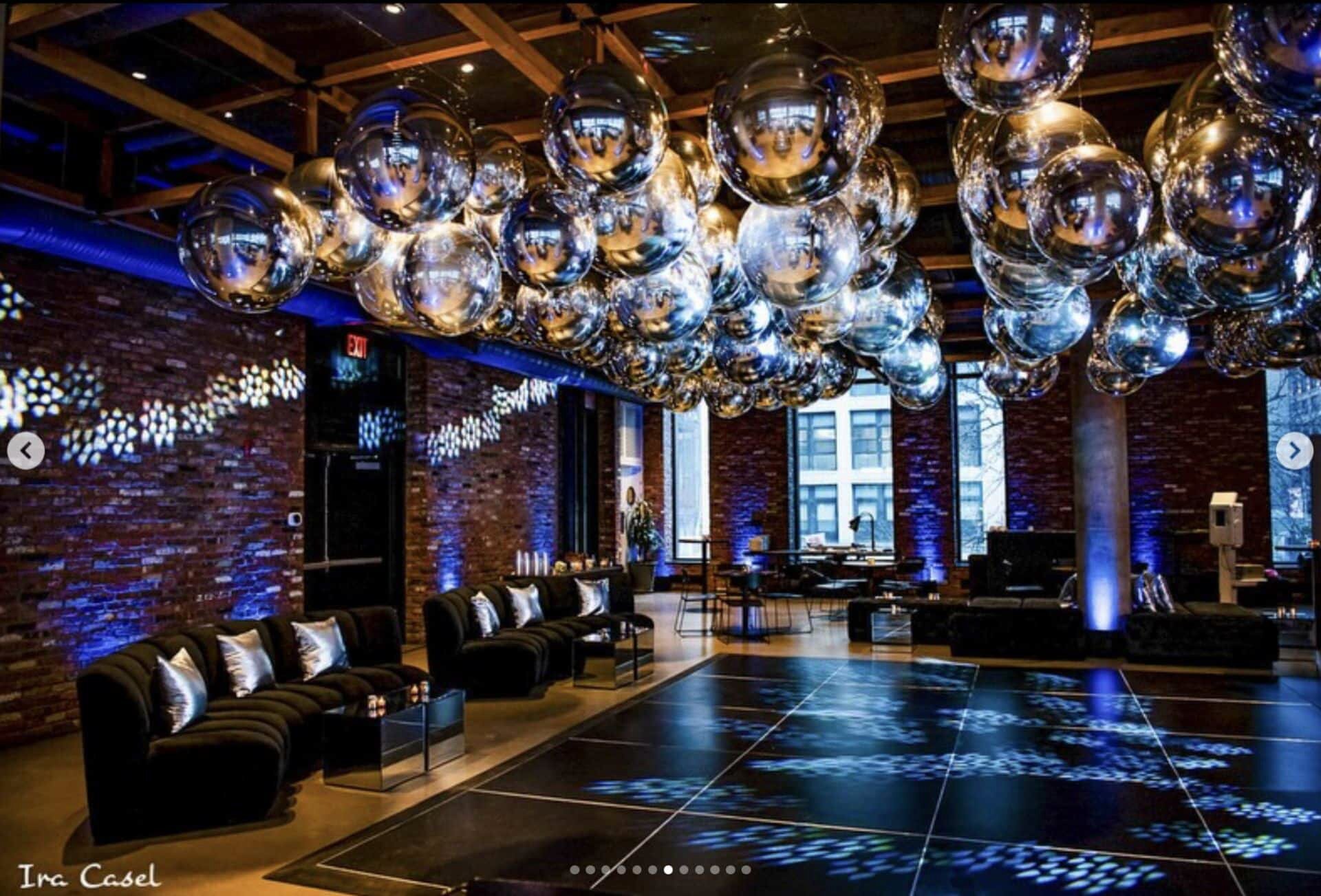 Silver balloon ceiling over a lounge with a dance floor